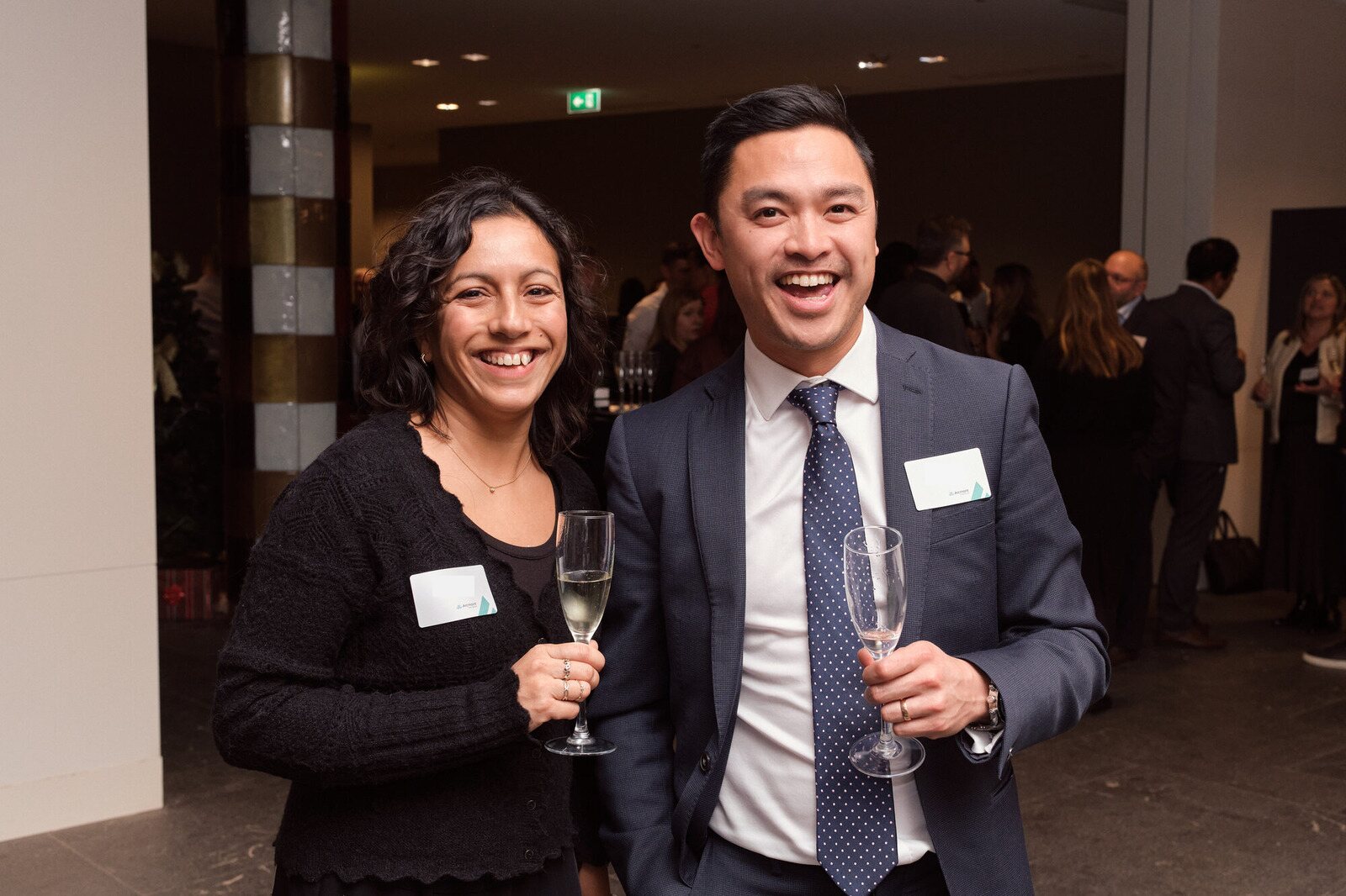 Arcmont — Two guests with a glass of champagne at the opening