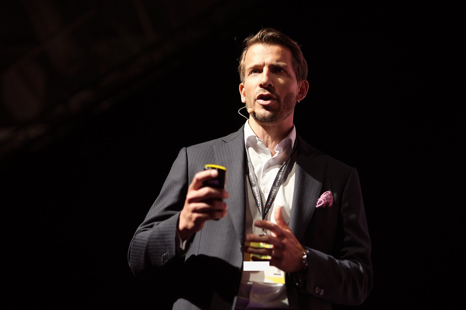 Paperjam — Keynote speaker on a dark stage, close-up