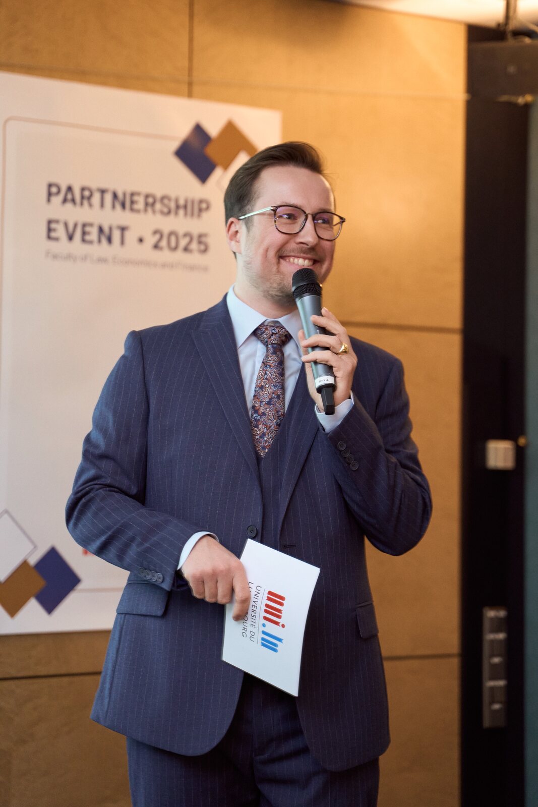 University of Luxembourg — Host with a microphone opening the evening