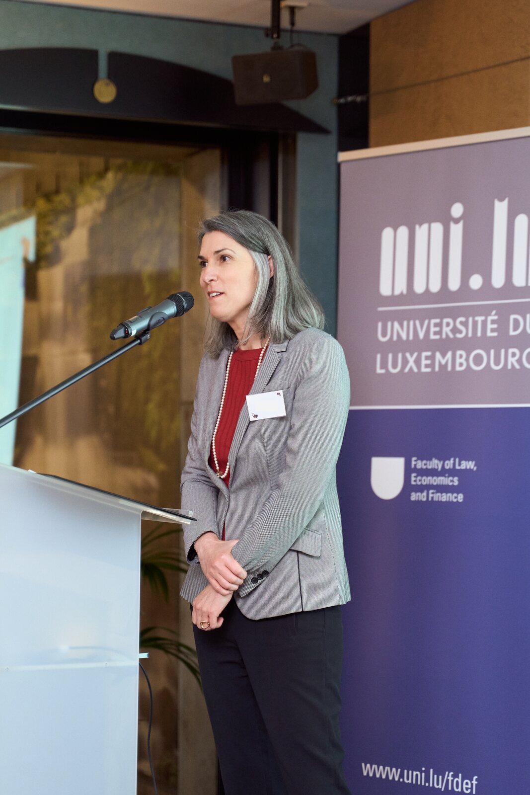 University of Luxembourg — Speech at the lectern next to the university banner